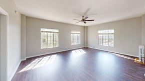 Los Angeles apartment for rent - A spacious room with wooden floors and a ceiling fan.