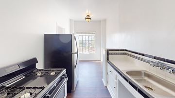 Los Angeles apartment for rent - A kitchen with a black stove and a black fridge.