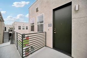 Ventura apartment for rent - A black door is on the side of a building with a number 321 on it.