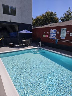 Van Nuys apartment for rent - a swimming pool in front of a building