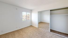 Van Nuys apartment for rent - A room with a carpeted floor and a sliding door.