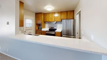 Inglewood apartment for rent - A kitchen with wooden cabinets and stainless steel appliances.
