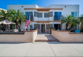 Long Beach apartment for rent - Belmont building with an American flag in front of it