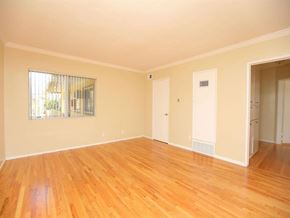 North Hollywood apartment for rent - Empty living room with hardwood floors and windows