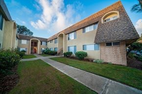 La Mesa apartment for rent - a walkway in front of a building with a sidewalk and grass