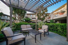 La Mesa apartment for rent - A patio with a table and chairs under a roof.