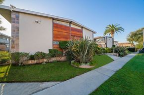 Inglewood apartment for rent - A modern house with a red and orange garage door.