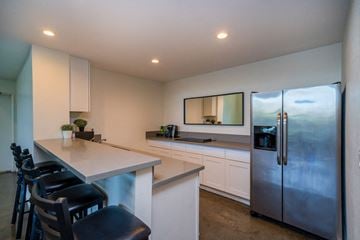 North Hollywood apartment for rent - A kitchen with a refrigerator, stove, and counter.