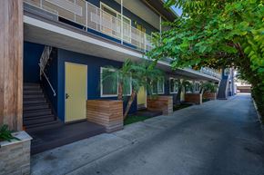 Inglewood apartment for rent - A long row of houses with blue walls and wooden steps leading to the front doors.