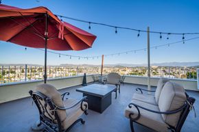 Los Angeles apartment for rent - A patio with two chairs and a table with a view of the city.