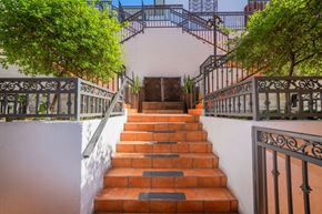 Los Angeles apartment for rent - A set of stairs with a metal railing on both sides.