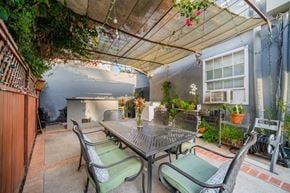 Los Angeles apartment for rent - A patio with a table and chairs under a canopy.