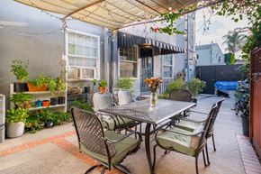 Los Angeles apartment for rent - A patio with a table and chairs under a canopy.