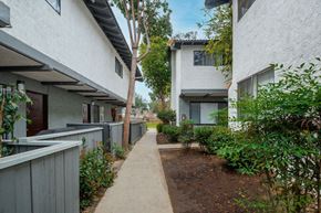 Ventura apartment for rent - A long concrete pathway leads between two buildings.