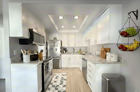 La Mesa apartment for rent - A modern kitchen with white cabinets and a black microwave.