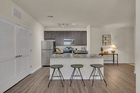Mount Holly apartment for rent - A kitchen with a bar stool in front of a counter at Heritage at Mount Holly, Mount Holly, New Jersey