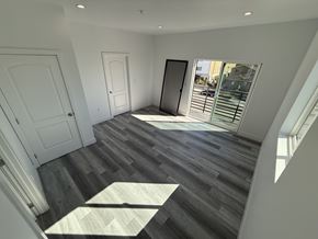 North Hollywood apartment for rent - A room with a wooden floor and white walls.