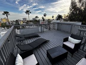 Los Angeles apartment for rent - A balcony with black furniture and a view of the city.