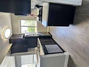 Van Nuys apartment for rent - A black television is mounted on a wall above a black drawer.