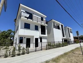 North Hollywood apartment for rent - A white building with black railings and windows.