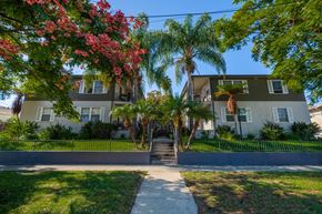 Los Angeles apartment for rent - a home with a sidewalk and palm trees in front of it