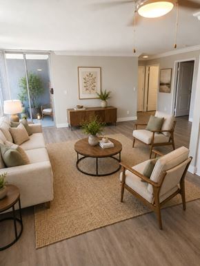 Van Nuys apartment for rent - A living room with a white couch, a wooden coffee table, and a rug.