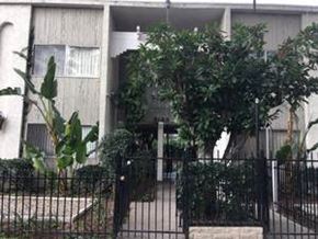 Van Nuys apartment for rent - Front of Building with Trees and black fence