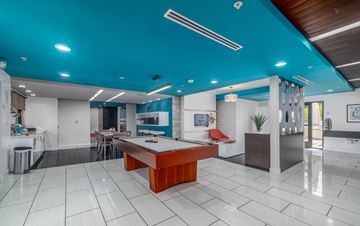Encino apartment for rent - A room with a pool table and a kitchen area.