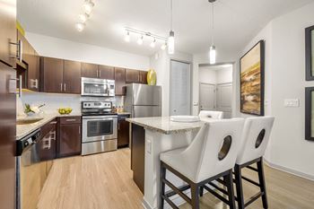 Our spacious kitchen and dining room are equipped with stainless steel appliances and granite countertops