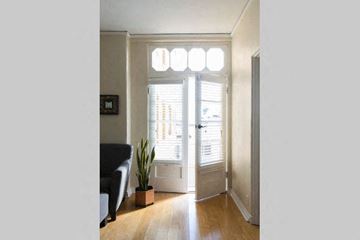 Los Angeles apartment for rent - a living room with a black couch and a plant