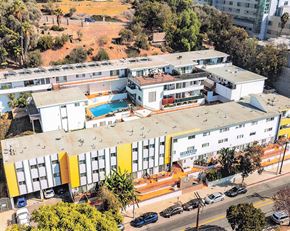 Los Angeles apartment for rent - A large white building with a pool in the middle.