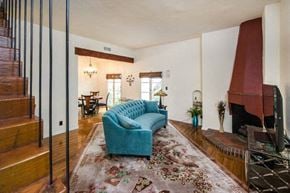 Los Angeles apartment for rent - Villa Valentino 17 Living Room turquois couch facing the fireplace