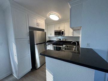 Van Nuys apartment for rent - a kitchen with a sink and a refrigerator