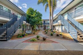 Ventura apartment for rent - courtyard with benches and trees at the whispering winds apartments in pearland, tx