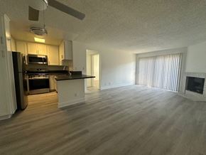 Van Nuys apartment for rent - an empty kitchen and living room with wood floors