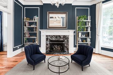 Chicago apartment for rent - a living room with two blue chairs and a fireplace