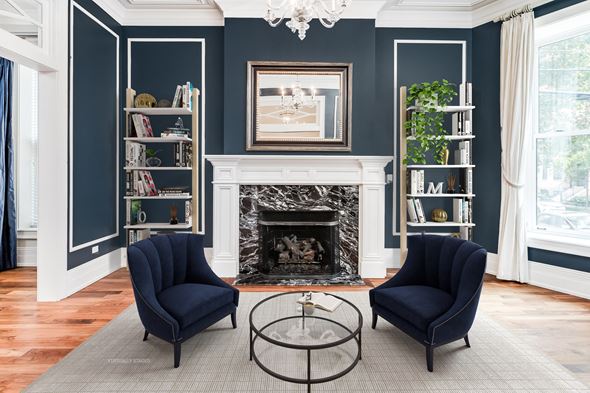 Chicago apartment for rent - a living room with two blue chairs and a fireplace