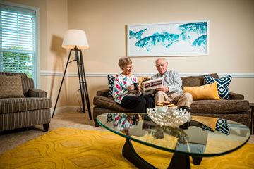 Pineville apartment for rent - An older couple sitting on a couch in a living room.