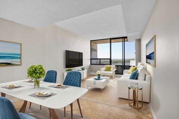 Ottawa apartment for rent - A modern living room with a dining table set for four.