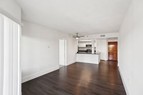 Atlanta apartment for rent - A spacious living room with faux wooden floors and white walls.