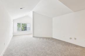 Lawrenceville apartment for rent - A spacious living room with a carpeted floor and a window.