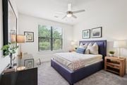 Atlanta apartment for rent - A large bedroom with a window and a ceiling fan.