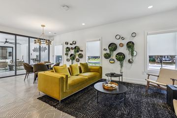 Lawrenceville apartment for rent - A living room with a yellow couch and a black and white rug.