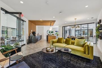 Lawrenceville apartment for rent - A modern living room with a yellow sofa and a coffee table.