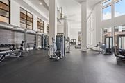Atlanta apartment for rent - A spacious gym with a variety of equipment and a large mirrors on the wall.