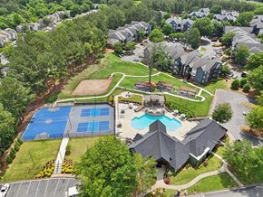 Lawrenceville apartment for rent - A bird's eye view of a residential area with a swimming pool and tennis court.