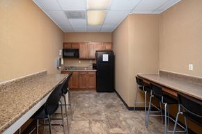 Atlanta apartment for rent - A kitchen with a black refrigerator, microwave, and oven.