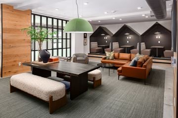 Douglasville apartment for rent - A modern living room with a large wooden table and comfortable seating.