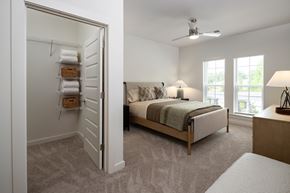 Douglasville apartment for rent - bedroom with guaranteed ceiling fan, walk-in closet, natural lighting, and tons of space for activities