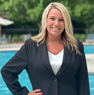 Newnan apartment for rent - A woman in a black suit stands by a pool.